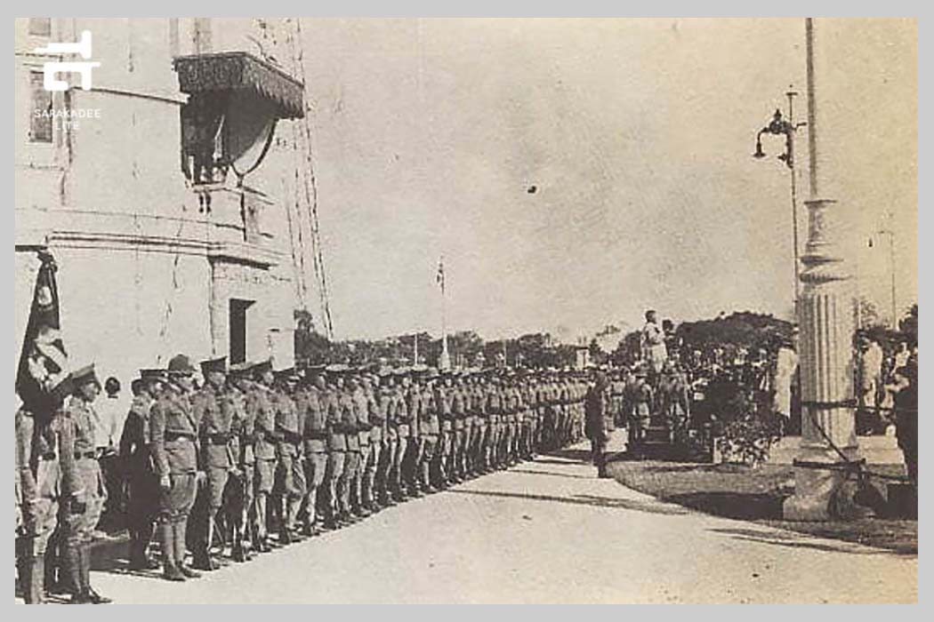 เมื่อในหลวงรัชกาลที่ 7 พระราชทานรัฐธรรมนูญแล้ว เจ้าพระยาพิชัยญาติ ประธานสภาผู้แทนราษฎรขณะนั้นได้อัญเชิญพานรัฐธรรมนูญขึ้นไปยืนบนเกยหน้าแถวทหาร ภาพ : หอจดหมายเหตุแห่งชาติ ตีพิมพ์ในนิตยสารสารคดี